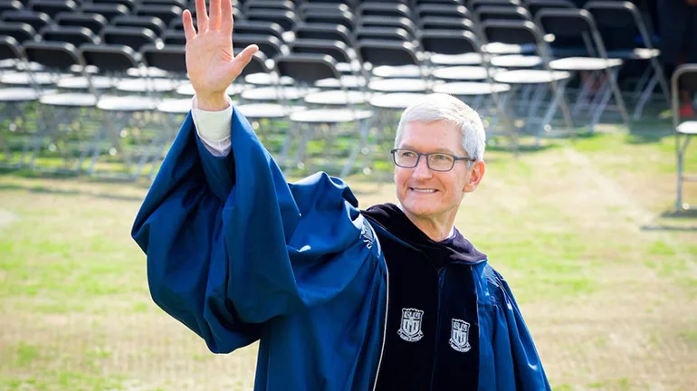 Apple CEO Tim Cook waves to students as he enters Wallace Wade Stadium